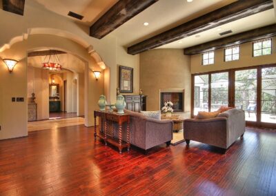 Open living room with wood beams and fireplace